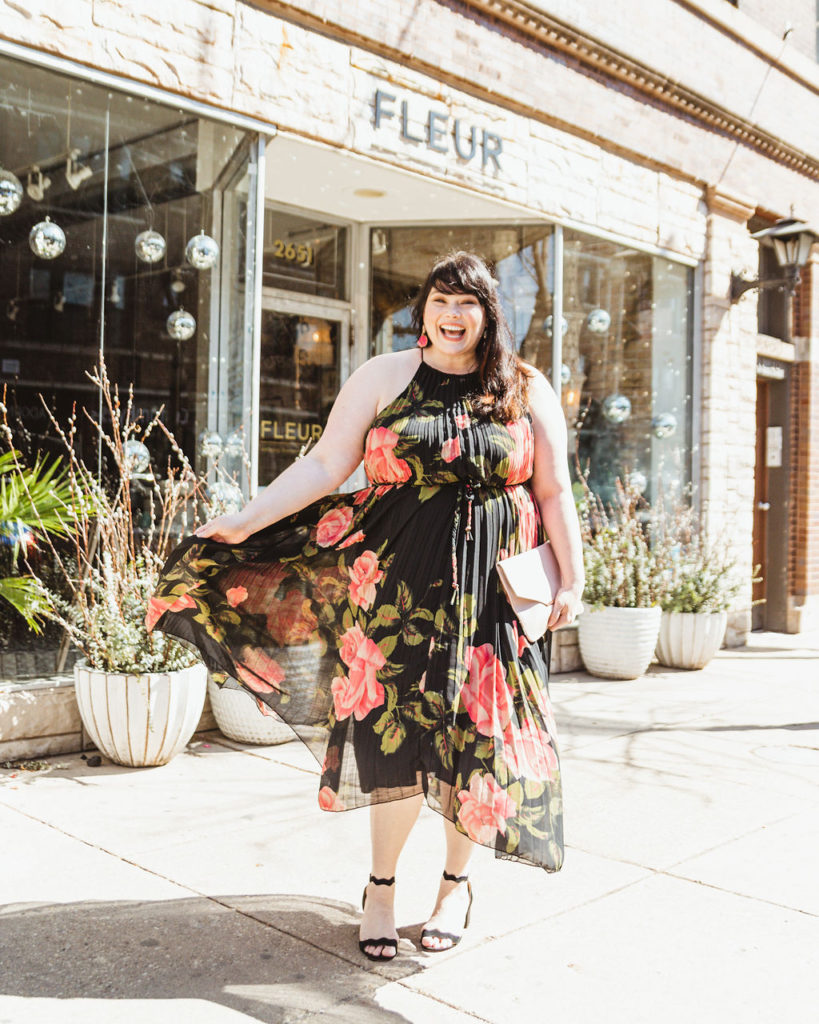 Chicago Plus Size blogger Amber in a Spring Outfit featuring a rose-printed plus size halter neck pleated dress.