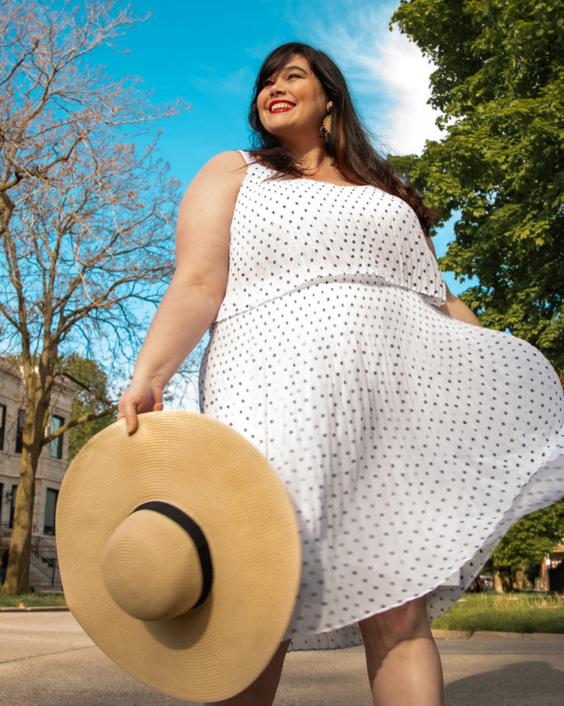 fashion blogger Amber in a polka dot dress and straw hat